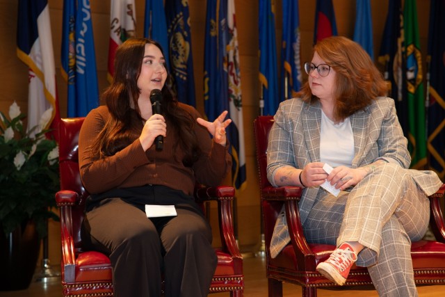 Victoria Fuhrmann, human resources specialist with the U.S. Communications-Electronics Command G1, discusses learning how to create a dashboard while Hannah Somers, also a human resources specialist with CECOM G1, looks on during the CECOM town...