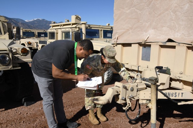 FORT CARSON, Colo. — Alonzo Blunt, Modernization Displacement and Repair Site contractor, reviews paperwork and inspects a trailer with Sgt. Fabiola Sotelo, 1st Stryker Brigade Combat Team, 4th Infantry Division, during a Feb. 5 unit turn-in on...