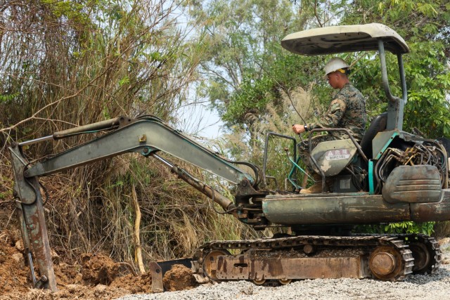 A U.S. Marine, assigned to the 9th Engineer Support Battalion, 3rd Marine Logistics Group, picks up dirt for a road rehabilitation project during joint exercise Cobra Gold 2025 at Ban Chan Khrem, Chanthaburi Province, Thailand, Feb. 20, 2025....