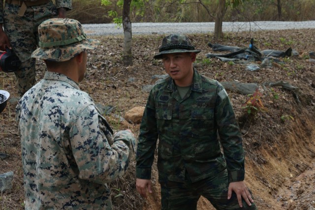 A U.S. Marine, assigned to the 9th Engineer Support Battalion, 3rd Marine Logistics Group, speaks to a first lieutenant of the Royal Thai Marine Corps, during Joint Exercise Cobra Gold 2025 at Ban Chan Khrem, Chanthaburi Province, Thailand, Feb....