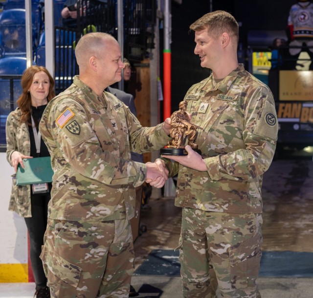 Col. James L. Crocker, Commander of Tobyhanna Army Depot, presented Staff Sgt. John T. Hogan with a bronze statue and Certificate of Achievement, honoring him as the second recipient of the Outstanding Active-Duty Servicemember award.