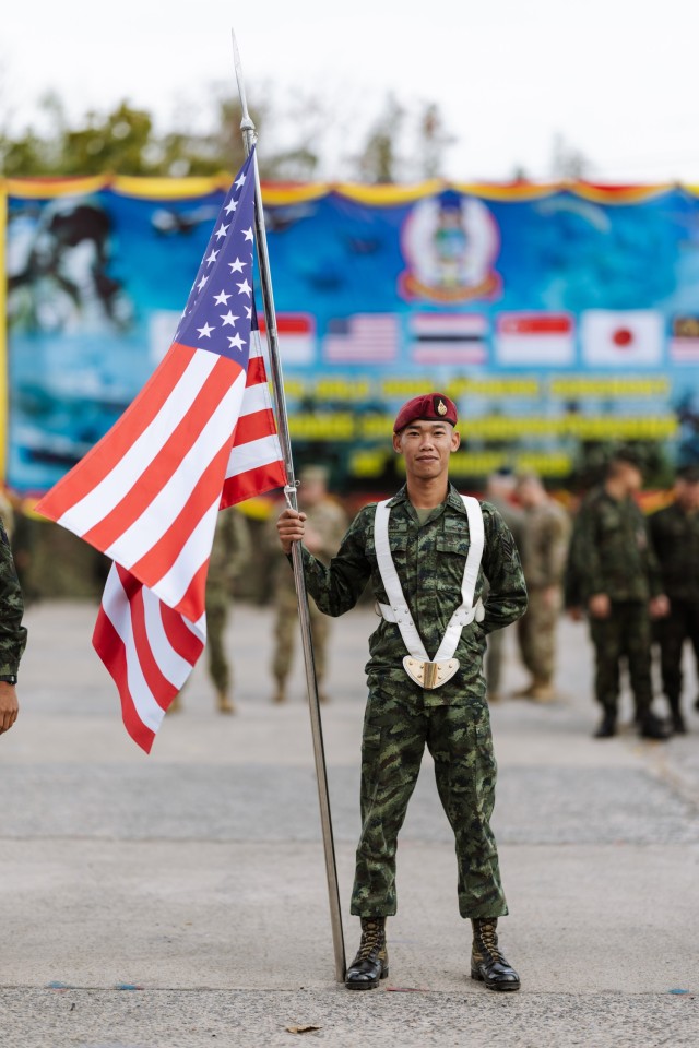 Royal Thai Armed Forces Soldier holds the American Flag during the Gold 2025 opening ceremony in Camp Suranaree, Thailand, February 25, 2025. The opening ceremony marks the 44th iteration of Cobra Gold, which started in 1982 and is the largest...