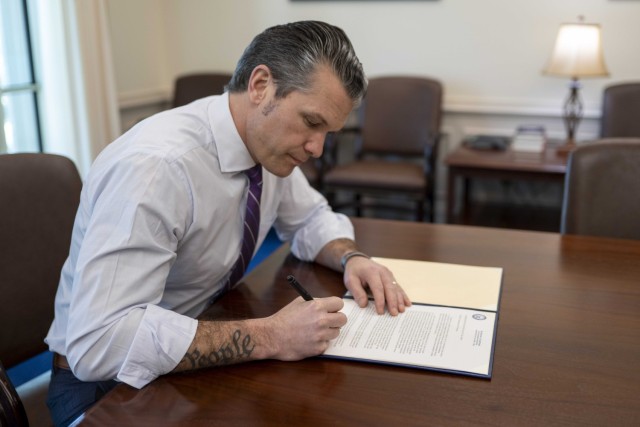 Defense Secretary Pete Hegseth signs a memorandum to rename Fort Moore, Ga. to Fort Benning at the Pentagon, March 3, 2025.