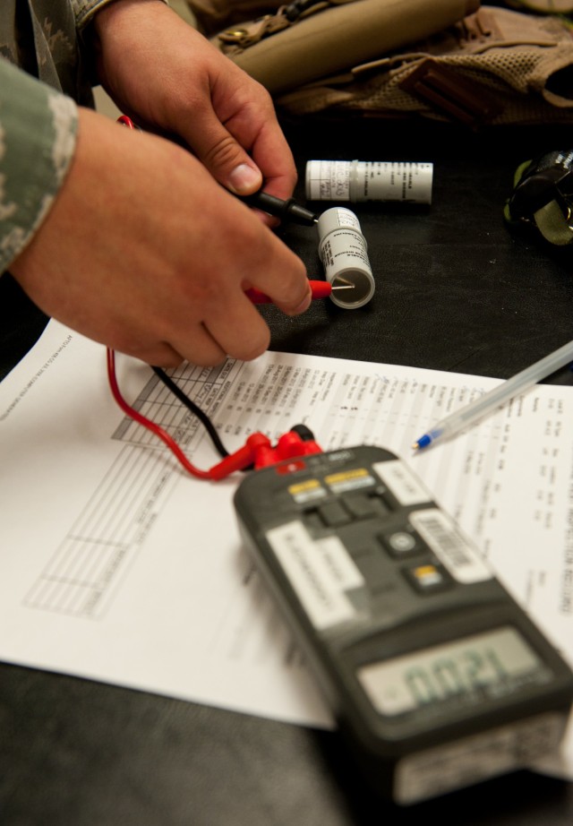 An airman tests lithium batteries from an aircrew survival vest during a routine inspection at the 34th Bomb Squadron on Ellsworth Air Force Base, S.D., July 25, 2012.
