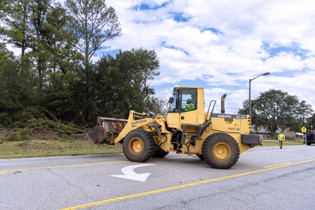 Crews use a wheel loader to clear roadways at Fort Eisenhower following Hurricane Helene. Fort Eisenhower has cleared approximately 464 miles of roads and 4,000 acres of the cantonment area, with costs for these operations totaling $36 million.