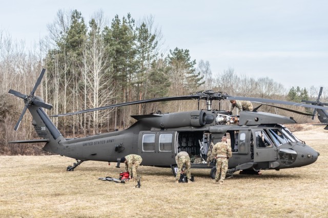 Soldiers from the 1st Battalion, 214th Aviation Regiment, 12th Combat Aviation Brigade prepare to conduct UH-60V Blackhawk gunnery tables at the Grafenwoehr Training Area, Germany, on March 4, 2025. This training maximized readiness by...