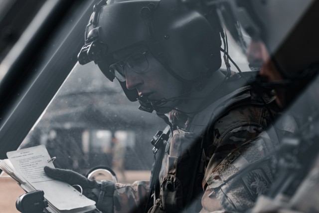 U.S. Army Capt. Brennan Schimmel, a pilot with the 1st Battalion, 214th Aviation Regiment performs pre-combat checks for a UH-60V Blackhawk prior to completing gunnery tables at the Grafenwoehr Training Area, Germany, March 4, 2025. This training...
