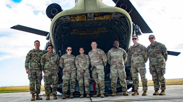 U.S. Army South leaders pose for a photo with Cpl. Samantha Juarez, center, a patriot fire control enhanced operator/maintainer in the USARSOUTH fires and effects directorate (FED), before her reenlistment ceremony at Naval Base Guantanamo Bay,...