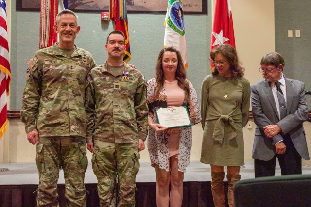 Capt. James McDaniel, assigned to 1st Stryker Brigade Combat Team, 4th Infantry Division, poses for a photo with his family after receiving the Purple Heart by Maj. Gen. David Doyle, commanding general of the 4th Infantry Division and Fort Carson,...