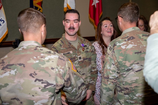 Capt. James McDaniel, assigned to 1st Stryker Brigade Combat Team, 4th Infantry Division, and his family members receive appreciation from attendees after his Purple Heart ceremony March 11, 2025, Fort Carson, Colorado. Established by General...