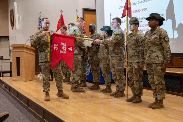 Maj. Gen. Christopher Beck, Maneuver Support Center of Excellence and Fort Leonard Wood commanding general, presents a certificate of achievement to Company A, 31st Engineer Battalion, while MSCoE Command Sgt. Maj. Jorge Arzabala attaches an Army...