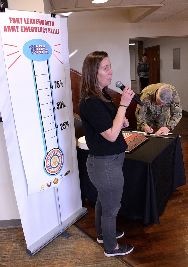 Reagan Sawyer, Army Community Service program manager, talks about Army Emergency Relief as Fort Leavenworth Garrison Commander Col. Duane Mosier fills out his AER pledge form during the annual campaign kickoff March 7, 2025, at the Frontier...