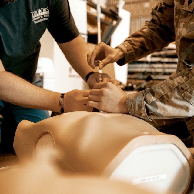 A Soldier from the 11th Cyber Battalion practices trauma response on a medical dummy, guided by Paul Aenchbacher of Doctors Hospital in Augusta, Ga., March 5, 2025. The training at Fort Eisenhower, Ga., was designed to prepare 11th Soldiers for...
