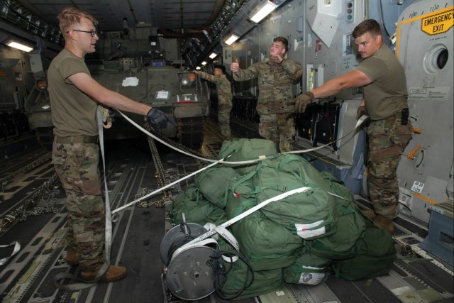Soldiers from the 3rd Infantry Division and U.S. Air Force airmen work together to secure gear on a C-17A Globemaster III aircraft during an emergency deployment readiness exercise at Hunter Army Airfield, GA, on 11 July 2024.