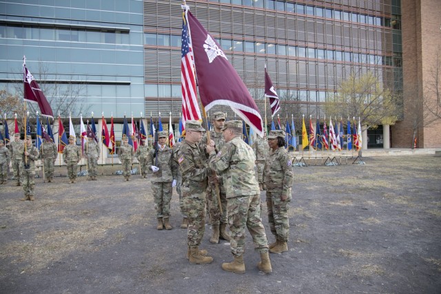 Col. Mark Stackle, commander, passes the guidon to Command Sgt. Maj. Jan “Eddy” Miller during a change of responsibility ceremony at Brooke Army Medical Center, Joint Base San Antonio – Fort Sam Houston, Texas, March 13, 2025. Miller assumed...