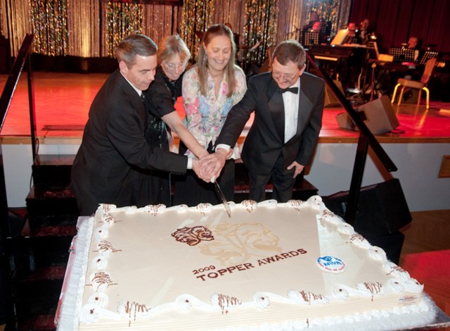 Jerry Brees, left, helps cut the cake at the 2009 TOPPER Awards held in Heidelberg, Germany....