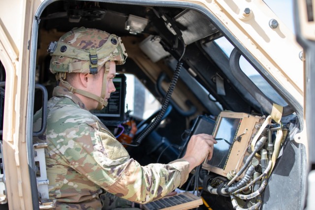 U.S. Army 1st Armored Division Soldier interfaces with technology during Project Convergence – Capstone 5 (PC-C5) at Fort Irwin, Calif. The technology in use demonstrates moving information quicker on the battlefield. PC-C5 is an Army-hosted...
