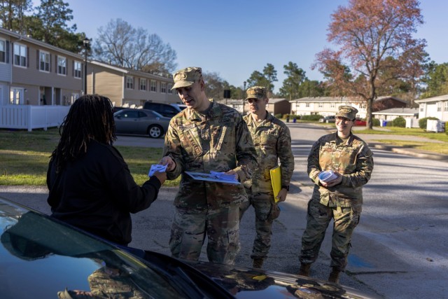 Representatives from Dwight D. Eisenhower Army Medical Center hands out a brochure about the MHS GENESIS Patient Portal during the Walking Town Hall on March 17, 2025, in Azalea Terrace. The portal provides beneficiaries with a streamlined way to...