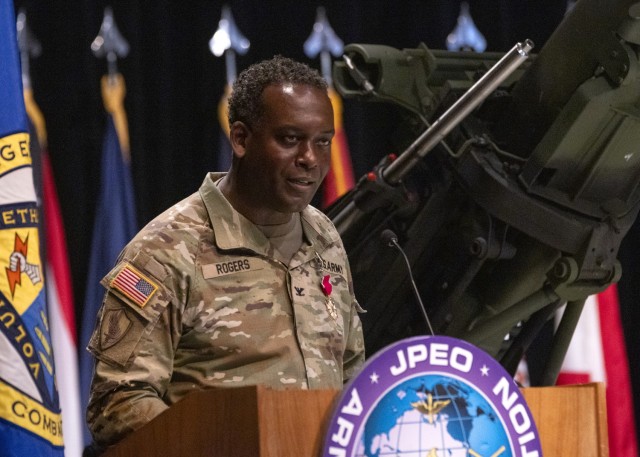 Outgoing Project Manager of Combat Ammunition Systems, Col. Leon Rogers, delivers his remarks after transferring management authority to Col. Alicia Johnson