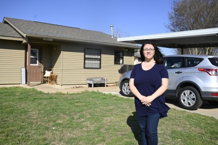Brittany Nguyen, president of the Cavalry Family Housing Resident Advisory Board, poses for a picture in front of her home March 14, 2025, at Fort Cavazos, Texas. Cavalry Family Housing won the SatisFacts 2024 Resident Satisfaction Community Award for all neighborhoods on the installation. 