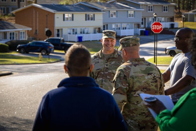 Col. Anthony Kazor, garrison commander, speaks with a resident of Azalea Terrace during the Walking Town Hall on March 17, 2025. The event allowed leadership to engage directly with residents, address concerns, and reinforce Fort Eisenhower's...