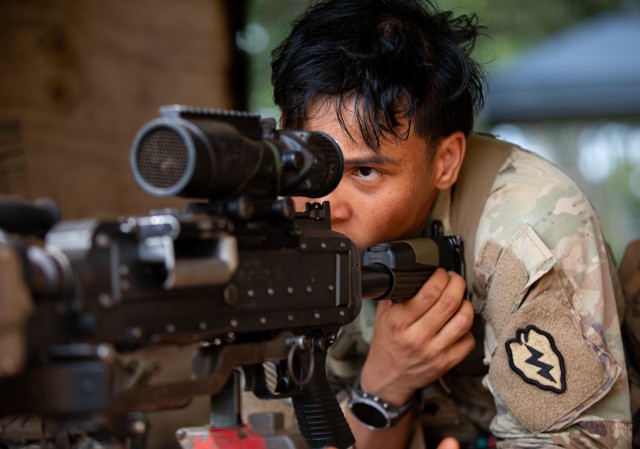 A U.S. Army Soldier assigned to the 25th Infantry Division adjusts their sights during a patrol lane training station in preparation for the Expert Infantry, Expert Soldier, and Expert Field Medical Badges (E3B) on Schofield Barracks, Hawaii,...