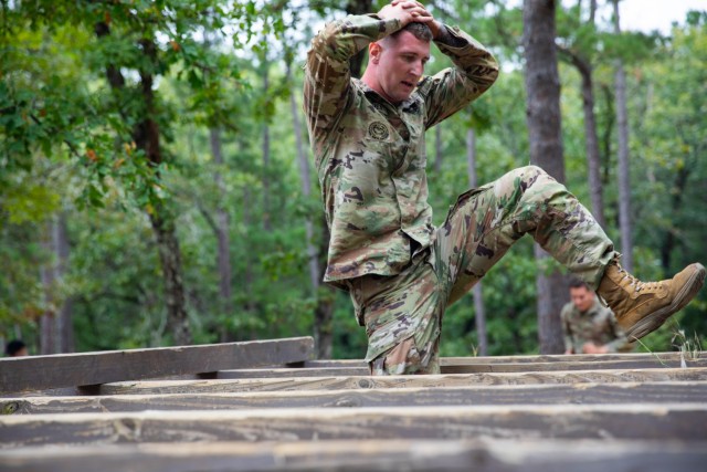 U.S. Army Drill Sergeant Forrest Minahen, assigned to the Aviation Center of Excellence, walks over an obstacle during the Fit to Win obstacle course at the Drill Sergeant of the Year competition at Fort Jackson, South Carolina, Sep. 16, 2024....