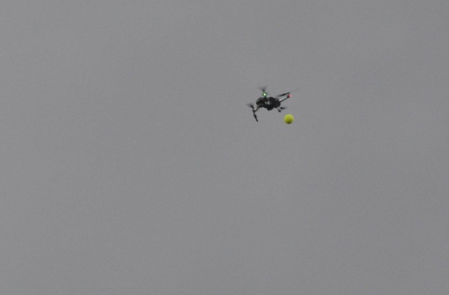 A small drone drops a tennis ball simulating an explosive device during an exercise at Fort Novosel.  The drones were tracked by a combination of radar and teams on the ground.