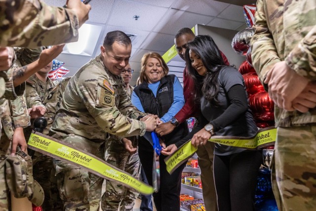 Fort Knox Garrison Command Sgt. Maj. Alex Licea is joined by Army and Air Force Exchange Services staff and multiple unit leaders during a ribbon cutting ceremony for the 1st Theater Sustainment Command barracks mini market at Fort Knox, Kentucky...