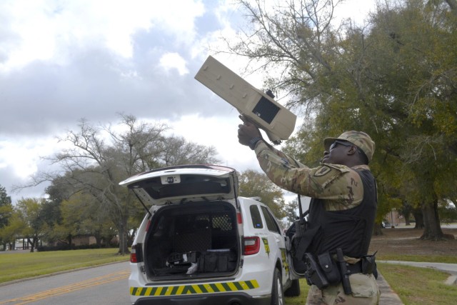 Military Police Sgt. Luke Tih with the U.S. Army Aviation Center of Excellence Law Enforcement Activity demonstrates the use of the Drone Buster jamming system during the Quantum Eagle exercise at Fort Novosel.