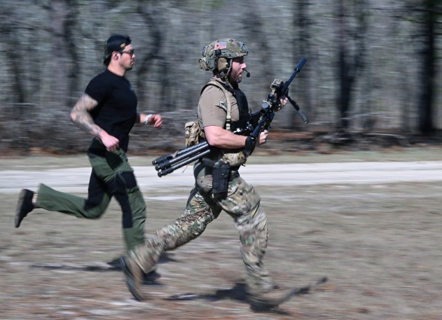 A competitor in the 16th Annual United States Army Special Operations Command International Sniper Competition runs across a range in a timed event, prior to engaging targets on a range at Fort Bragg, North Carolina, March 19, 2025. Twenty-one...