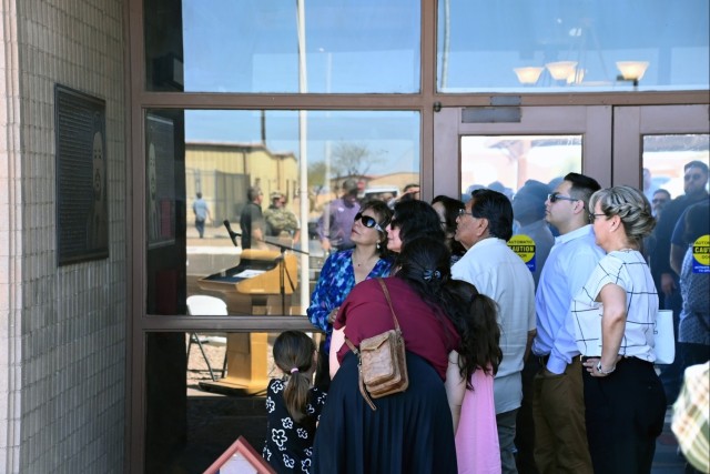 Members of the Bracamonte Family admire the plaque placed in his honor on the side of the Bracamonte Range Operations Center at U.S. Army Yuma Proving Ground after a ceremony renaming the building on March 24, 2025.