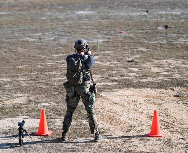 A competitor in the 16th Annual United States Army Special Operations Command International Sniper Competition fires a pistol at various targets on a range at Fort Bragg, North Carolina, March 19, 2025. Twenty-one teams competed in the USASOC...