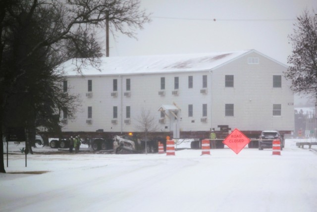 A barracks building from the 1600 block at Fort McCoy, Wis., is shown being moved Feb. 12, 2025, from the 1600 block to another area of the installation. Contractors are moving several buildings in January and February 2025. These buildings will...