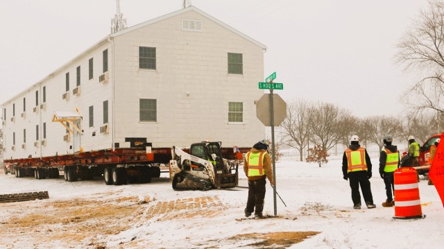 A barracks building from the 1600 block at Fort McCoy, Wis., is shown being moved Feb. 12, 2025, from the 1600 block to another area of the installation. Contractors are moving several buildings in January and February 2025. These buildings will...