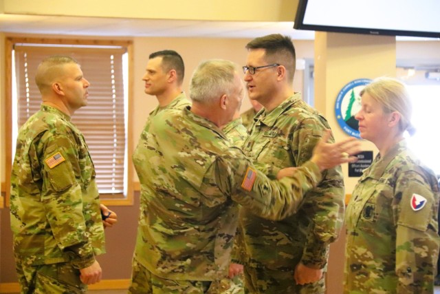 A scene from a patching ceremony held March 13, 2025, is shown in building 905 at Fort McCoy, Wis. Soldiers with U.S. Army Garrison-Fort McCoy traded out the Army Materiel Command patches on their uniforms for the blue clover patch of the 88th...