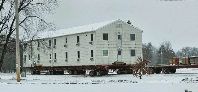 A barracks building from the 1600 block at Fort McCoy, Wis., is shown being moved Feb. 12, 2025, from the 1600 block to another area of the installation. Contractors are moving several buildings in January and February 2025. These buildings will...