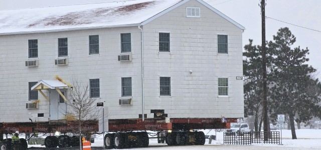 A barracks building from the 1600 block at Fort McCoy, Wis., is shown being moved Feb. 12, 2025, from the 1600 block to another area of the installation. Contractors are moving several buildings in January and February 2025. These buildings will...