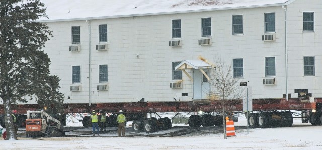A barracks building from the 1600 block at Fort McCoy, Wis., is shown being moved Feb. 12, 2025, from the 1600 block to another area of the installation. Contractors are moving several buildings in January and February 2025. These buildings will...