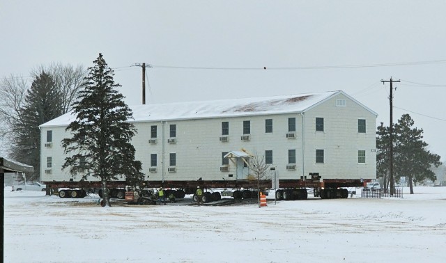 A barracks building from the 1600 block at Fort McCoy, Wis., is shown being moved Feb. 12, 2025, from the 1600 block to another area of the installation. Contractors are moving several buildings in January and February 2025. These buildings will...
