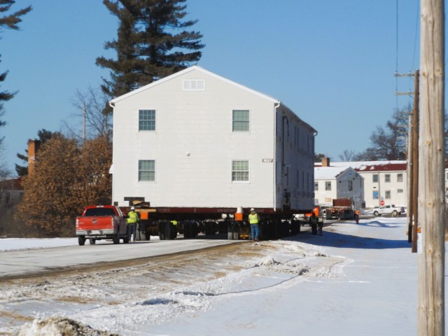 A barracks building from the 1600 block at Fort McCoy, Wis., is shown being moved Feb. 13, 2025, from the 1600 block to another area of the installation. Contractors are moving several buildings in January and February 2025. These buildings will...