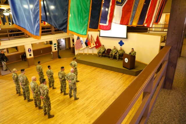 A scene from a patching ceremony held March 13, 2025, is shown in building 905 at Fort McCoy, Wis. Soldiers with U.S. Army Garrison-Fort McCoy traded out the Army Materiel Command patches on their uniforms for the blue clover patch of the 88th...