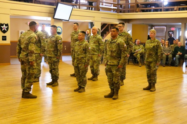 A scene from a patching ceremony held March 13, 2025, is shown in building 905 at Fort McCoy, Wis. Soldiers with U.S. Army Garrison-Fort McCoy traded out the Army Materiel Command patches on their uniforms for the blue clover patch of the 88th...