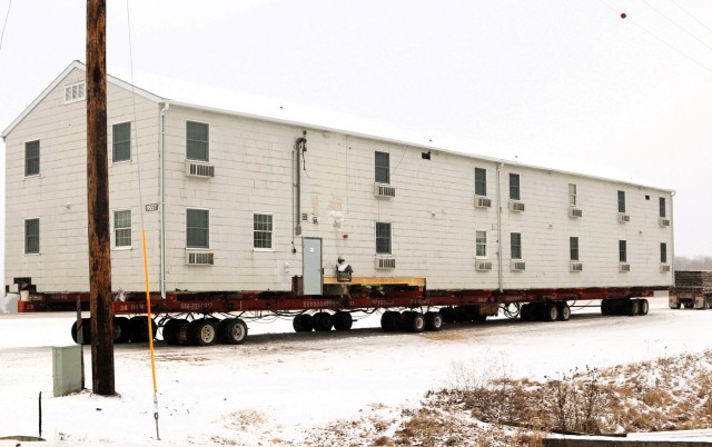 A barracks building from the 1600 block at Fort McCoy, Wis., is shown being moved Feb. 12, 2025, from the 1600 block to another area of the installation. Contractors are moving several buildings in January and February 2025. These buildings will...