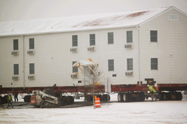 A barracks building from the 1600 block at Fort McCoy, Wis., is shown being moved Feb. 12, 2025, from the 1600 block to another area of the installation. Contractors are moving several buildings in January and February 2025. These buildings will...