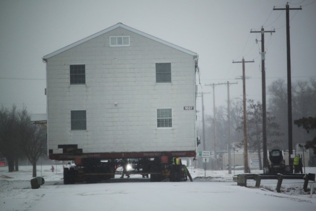 A barracks building from the 1600 block at Fort McCoy, Wis., is shown being moved Feb. 12, 2025, from the 1600 block to another area of the installation. Contractors are moving several buildings in January and February 2025. These buildings will...