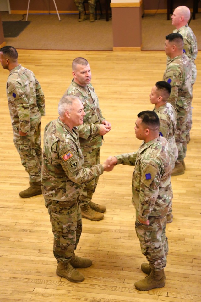 A scene from a patching ceremony held March 13, 2025, is shown in building 905 at Fort McCoy, Wis. Soldiers with U.S. Army Garrison-Fort McCoy traded out the Army Materiel Command patches on their uniforms for the blue clover patch of the 88th...