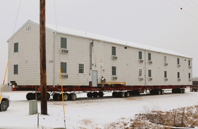 A barracks building from the 1600 block at Fort McCoy, Wis., is shown being moved Feb. 12, 2025, from the 1600 block to another area of the installation. Contractors are moving several buildings in January and February 2025. These buildings will...
