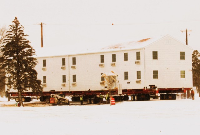 A barracks building from the 1600 block at Fort McCoy, Wis., is shown being moved Feb. 12, 2025, from the 1600 block to another area of the installation. Contractors are moving several buildings in January and February 2025. These buildings will...