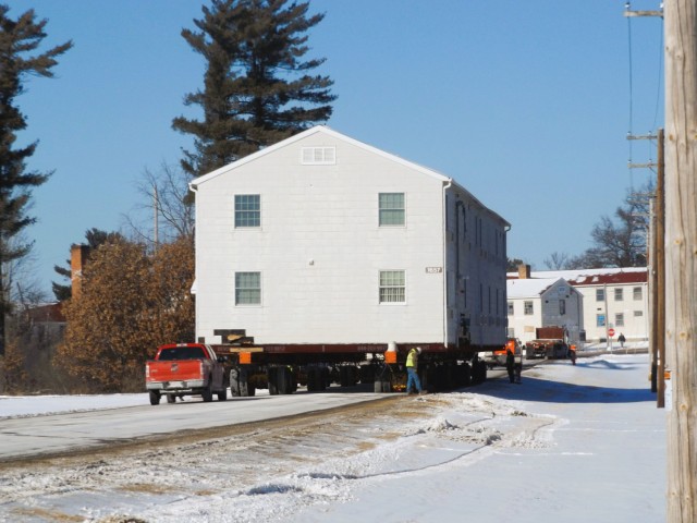 A barracks building from the 1600 block at Fort McCoy, Wis., is shown being moved Feb. 13, 2025, from the 1600 block to another area of the installation. Contractors are moving several buildings in January and February 2025. These buildings will...